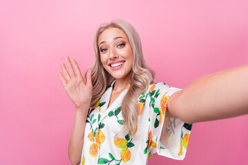 Portrait of cheerful woman with wavy hairstyle wear stylish print shirt waving palm on selfie...
