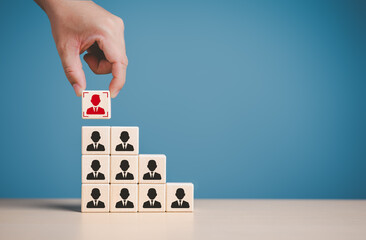 CEO or manager hand choosing people icons on wooden cube blocks. Business hiring and recruitment...