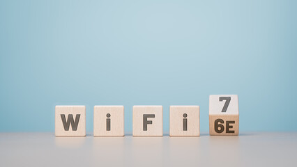 WiFi 6 to 7 symbol. Wooden cube blocks flipping from words WiFi 6e to WiFi 7. Transformation...