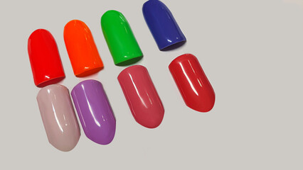 Palette of multi-colored nail polishes. Manicure and gel polish color choice.