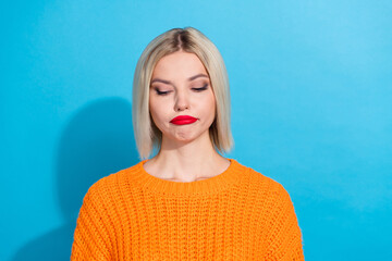 Portrait of disappointed woman with bob hair dressed knitwear sweater guilty look at empty space isolated on blue color background