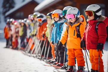Fotobehang Ski school children in line. Happy children. Children learning how to ski with their coach. Ski holiday, Children learning to ski Bavaria, Germany. © VisualProduction
