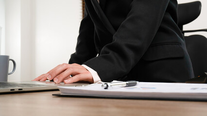 Busineswoman working in office using laptop.