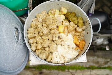 Siomay in the pan and ready to be sold. Siomay are fish cake dumplings with potatoes, eggs and rolled cabbage served with peanut sauce and chili. Siomay is a traditional Indonesian culinary food.