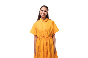 smiling young woman dressed in a summer yellow dress on a white background