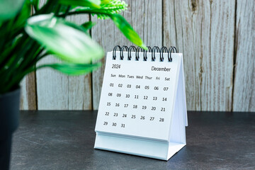 White December 2024 calendar on wooden desk. 2024 New Year Concept