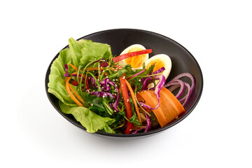Fresh arugula salad with carrot, eggs, iceberg lettuce, isolated on white background.