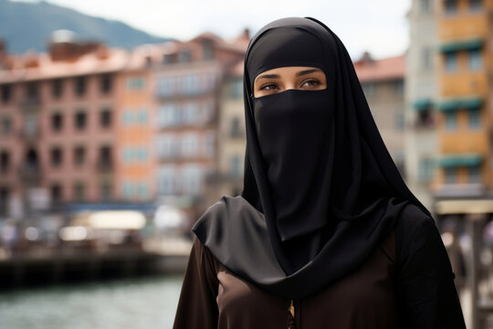 Beautiful Muslim woman wearing burqa in European city on sunny day.