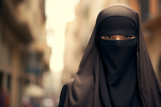 Beautiful Muslim woman wearing burqa in European city on sunny day.