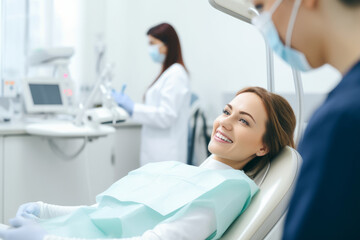 Happy female patient in dental chair waiting to be checked by a dentist. Healthy white teeth and perfect smile, healthcare.