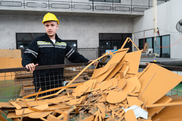 Caucasian engineer man working with recycle brown paperboard in office at paper factory	