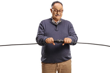 Cautious mature man plugging cables