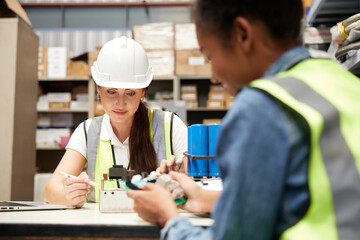 factory workers checking and fixing small machine or mainboard in the factory