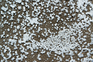 Crystals of self-precipitating common salt (sodium chloride) crystallized at the bottom