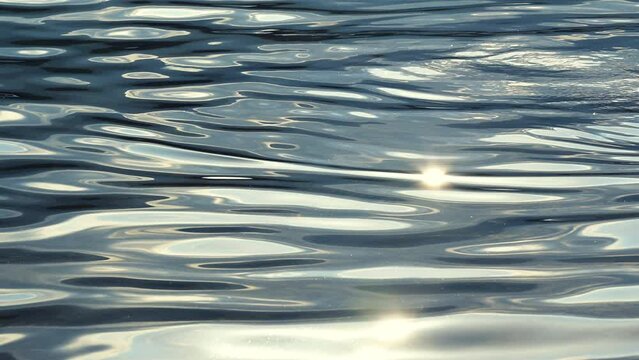 Glittering water surface of Lake Bohinj in Triglav national park in Slovenia in sunny summer afternoon, shot at 120 fps in 4k