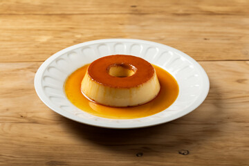 milk pudding, delicious dessert with caramel on a white dish.