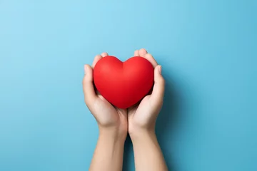 Poster hands holding red heart, health care, love, organ donation, mindfulness, wellbeing, family insurance and CSR concept, world heart day, world health day, world mental health day, praying concept © olyphotostories