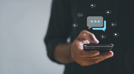 With smartphone in hand, man engages in live chat, personifying social network and chatting concepts. In chat box, he symbolizes essence of modern communication and digital engagement.
