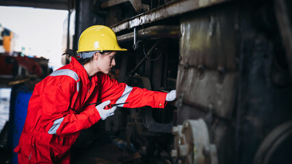 Industrial engineers inspect and perform maintenance on the machines at factory machines. Teamwork in the Manufacturing Industry in the train garage.