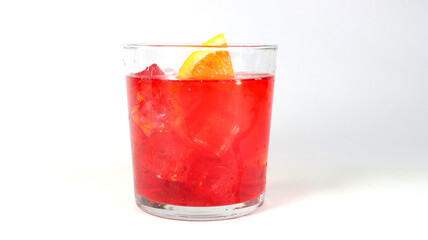closeup of a red cocktail with ice cubes,  orange slice on a white background