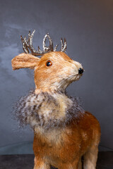 close-up of a deer's head on a gray background. fawn statue for new year decor
