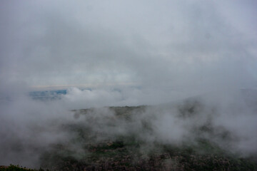 Cloudy and windy day on Cadillac Mountain summit with views of Bar Harbor and its many islands.