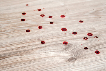 Drops blood stains from menstruation on white fluffy carpet. daily life stain concept. top view. 