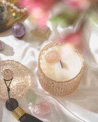 Vegan handmade candle with rose quartz. Soy, coconut candle with wooden wick. Aesthetic interior, eco home decoration. Selective focus