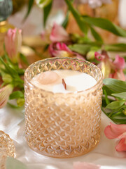Vegan handmade candle with rose quartz. Soy, coconut candle with wooden wick. Aesthetic interior, eco home decoration. Selective focus
