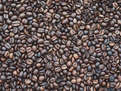 Dark rich roasted coffee beans background image.