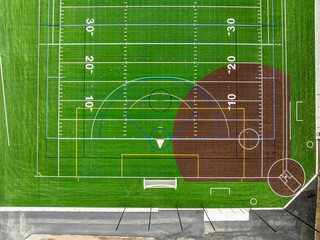 New synthetic turf field with football and baseball with lines and graphics.	