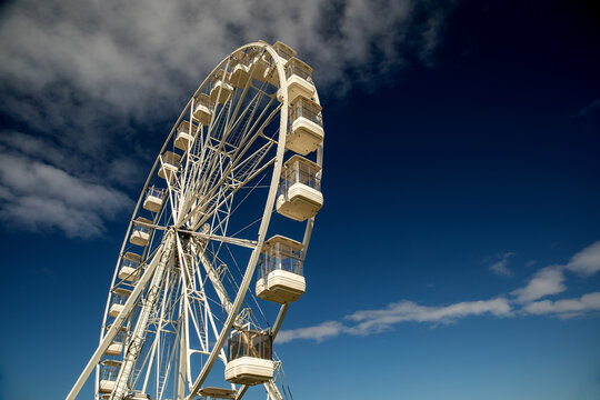 Ferris Wheel at a Fairground Against a Clear Blue Sky
