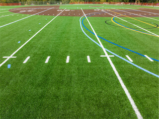 New synthetic turf field with football and baseball with lines and graphics.	