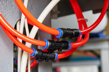 orange duct tubes of pneumatic system connected by the fittings