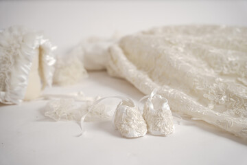 Baby vintage victorian outfit. new baby born white dresss with shoes and head wear on a white background.          