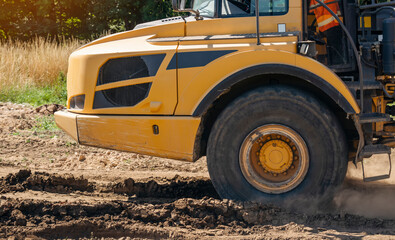 Close-up of the big yellow articulated dump truck earth mover