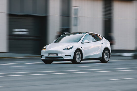 Tesla Model Y all electric car driving down the street