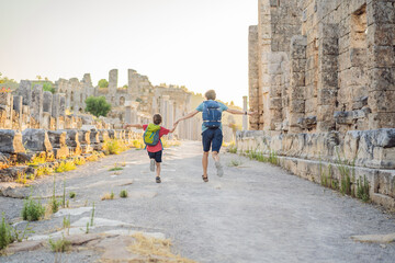 dad and son tourists at the ruins of ancient city of Perge near Antalya Turkey. Traveling with kids...