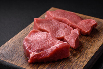 Raw fillet steak mignon beef with salt, spices and herbs