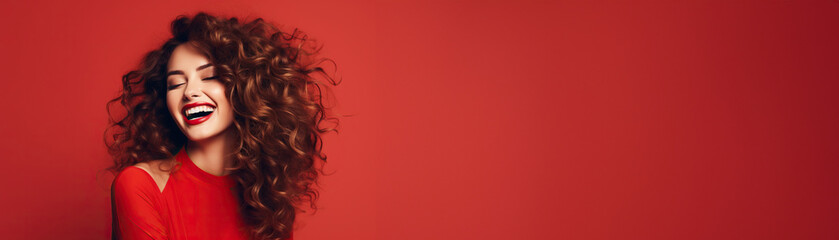 Smiling woman hairstyle wavy curls with red lips on red studio background