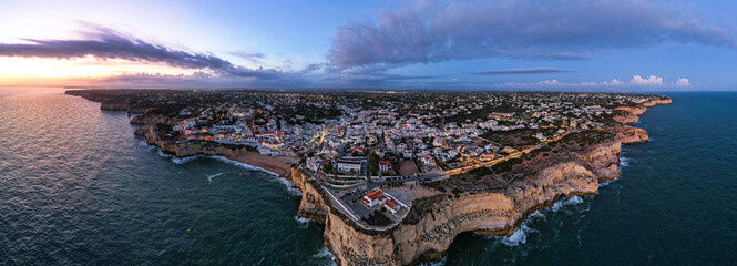 Evening at Carvoeiro popular tourist town in Algarve , Portugal. Aerial drone view