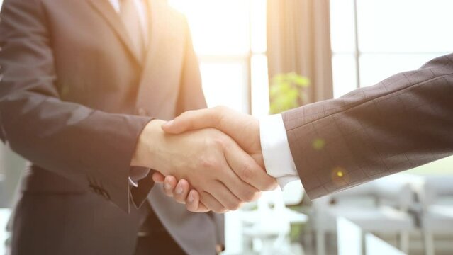 Building a strong business network. two businessmen shaking hands in a modern office