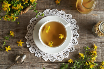 Fresh St. John's wort flowers in a cup of herbal tea in a white cup