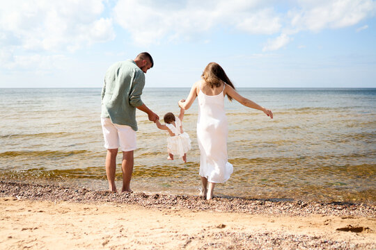 A happy family having fun on summer vacation. Baltic sea, Latvia