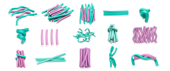 Set of different hair curlers on white background