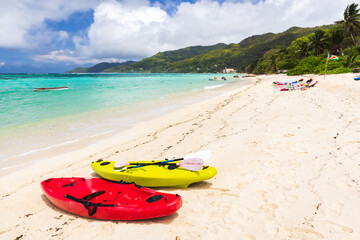 Seychelles beach view. Colorful plastic kayaks