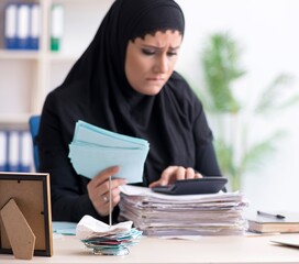 Female employee bookkeeper in hijab working in the office