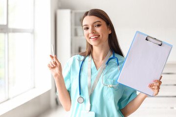 Female medical intern with clipboard at hospital