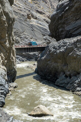 A camper crossing a bridge and previously a tunnel in Pato Canyon
