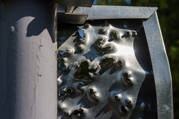 Metal shield shot from shotgun shot, exit holes in the metal - obrazy, fototapety, plakaty